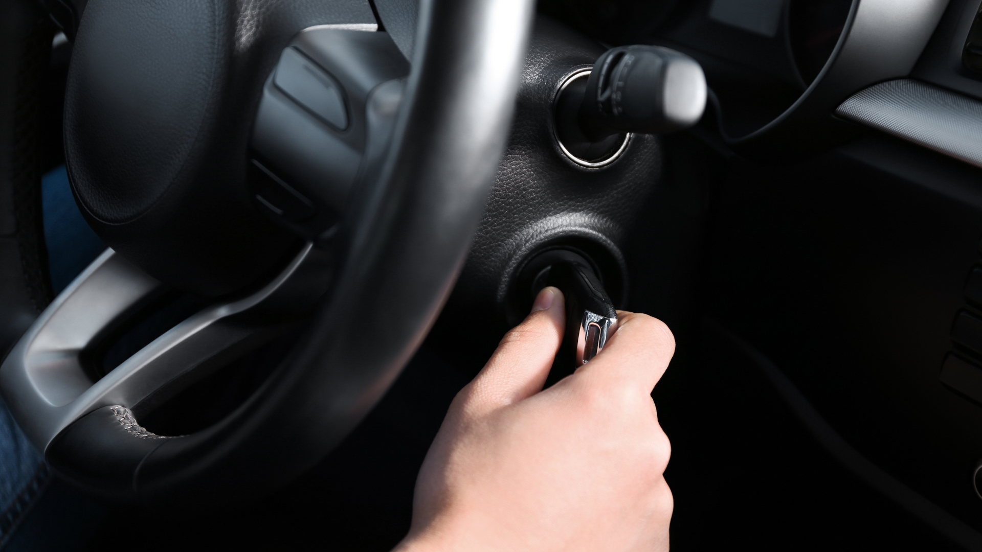 A driver turning the key in the ignition after the ignition switch replacement