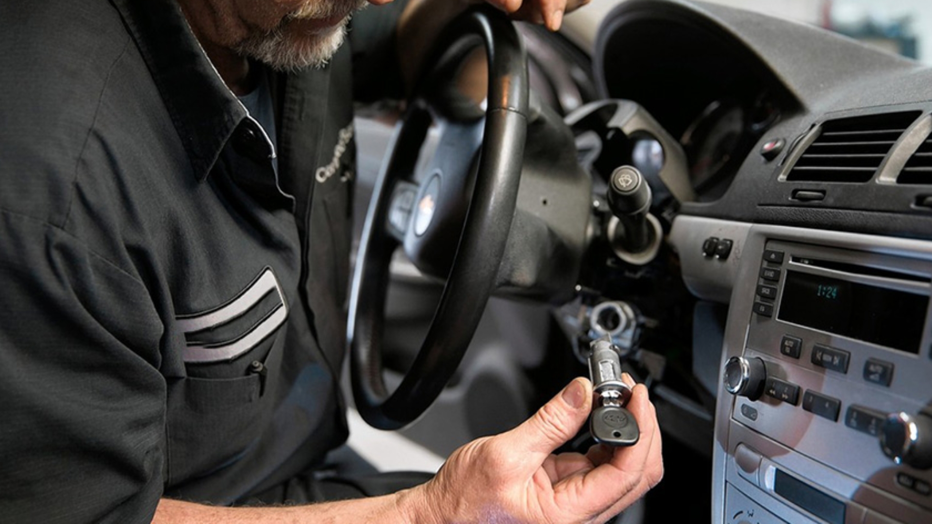A locksmith performing ignition switch replacement